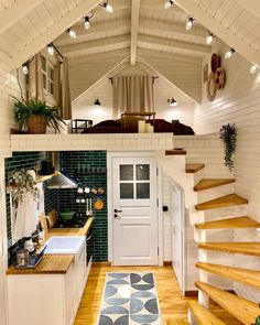 a kitchen and stairs in a tiny house