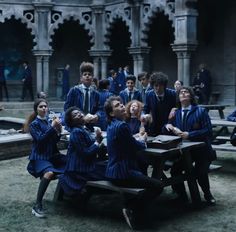 a group of young people sitting around a table