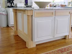 a kitchen island with a bowl on it in the middle of a hardwood flooring area