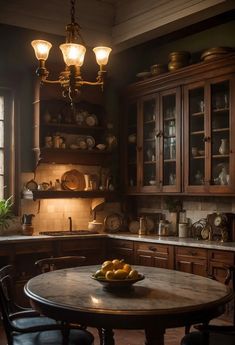 an old fashioned kitchen with wooden cabinets and marble counter tops is lit by two hanging lights