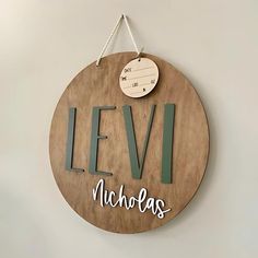 a wooden sign hanging on the wall that says levi, nicholas and he will be there