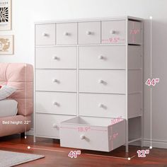 a white dresser sitting next to a pink chair in a room with measurements for drawers