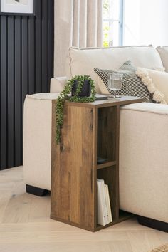 a living room with a white couch and wooden table in it's centerpiece