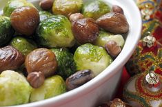 brussel sprouts and nuts in a white bowl on a red tablecloth