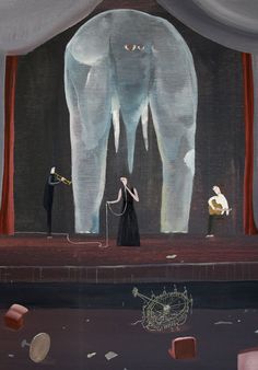 an elephant standing in front of a stage with two people on it's sides