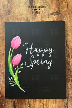 a black card with pink flowers and the words happy spring written on it