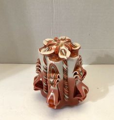 a ceramic vase sitting on top of a white table