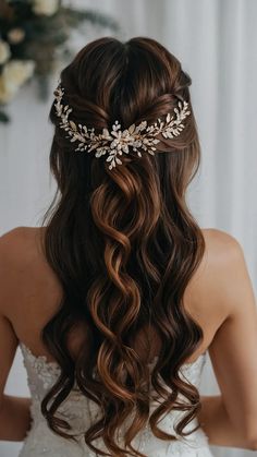 a woman wearing a bridal hair comb with flowers in the back and leaves on top