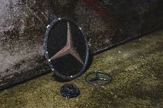 a mercedes emblem is sitting on the ground