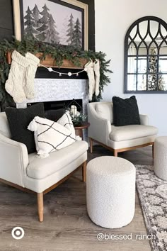 a living room with white furniture and christmas decorations