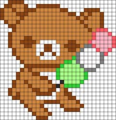 a cross stitch pattern with a teddy bear holding a green object in it's mouth