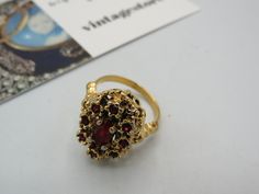 spectacular vintage gold tone KARATCLAD SIGNED stunning cocktail ring, beautiful ornate design with deep red rhinestones, high end great condition , size M Ornate Gold Ruby Ring, Ornate Gold Ring With Ruby, Ornate Gold Rings With Ruby, Vintage Ruby Gold Rings, Vintage Gold Jeweled Rings, Vintage Jeweled Rings For Party, Vintage Gold Ruby Ring Collectible, Vintage Collectible Ruby Ring, Vintage Jeweled Rings