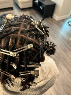 a close up of a person's hair with scissors on top of the combs