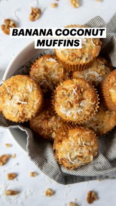 a white bowl filled with muffins on top of a table next to nuts