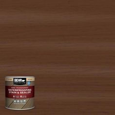 a can of behr wood stain sitting on top of a wooden floor