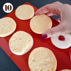 a person is making pancakes on a red tray