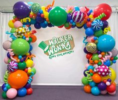 an arch made out of balloons and candy canes with the words walker wonka on it