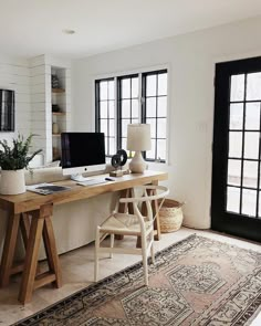 the instagram page shows an image of a desk with a computer on it and a rug