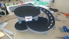 the table is made out of cardboard and has black and white checkered designs on it