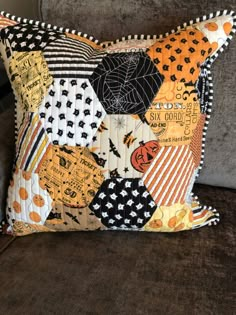 a patchwork pillow is sitting on a couch