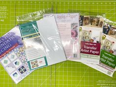 there are many different papers on the cutting board, including one for quilters companion