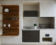 a room with some shelves and a clock on the wall next to a window in it