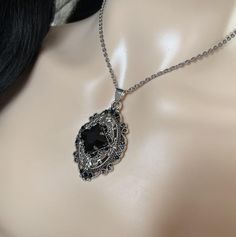 This richly detailed antiqued silver plated filigree pendant, is adorned with dazzling JET BLACK glass rhinestones that perfectly accentuate a larger jewel in the center. Pendant measures 2 1/4" tall (including the bail) and 1 1/4" wide. It is worn on a cable chain in your choice of length and fastens with a lobster clasp.Listing is for necklace ONLY. Matching earrings are listed in our store.This is available in a variety of stone colors in our store, along with matching earrings. If you don't Silver And Black Jewlery Necklaces, Necklace Katherine Pierce, Black Jewelry Necklace Stone, Dark Victorian Jewelry, Gothic Jewelry Necklaces Dainty, Victorian Style Necklace, Nickel-free Black Jewelry For Wedding, Nickel-free Black Wedding Jewelry, Antique Black Necklace With Oxidized Finish