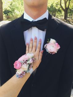 a man in a tuxedo with flowers on his lapel and the bride's wedding ring