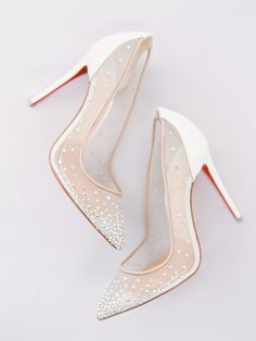 two pairs of white high heel shoes with pearls on them