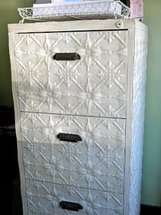 a white dresser with two drawers on top of it