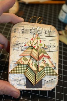 someone is making a christmas tree ornament out of scraps and fabric material