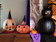 three pumpkins with faces painted on them sitting next to candles and other decorative items