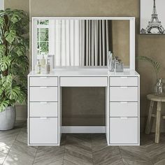 a white dressing table with mirror, stool and potted plant in front of it