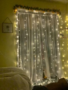 a bedroom decorated with lights and curtains