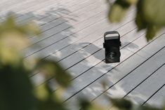 a camera sitting on top of a wooden deck