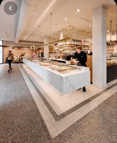 the interior of a restaurant with food on display