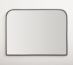 a mirror that is on the wall with a black border around it and a white background