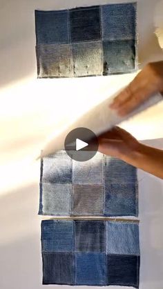 someone is painting the wall with blue and gray squares on it, while another person holds up a piece of paper