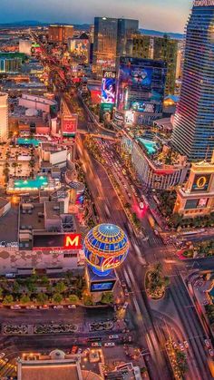 an aerial view of the las vegas strip at night with neon lights and hotels in the background