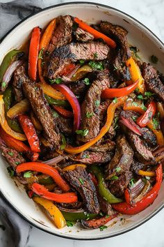 Make dinner sizzle with these easy steak fajitas! Seared to perfection in a cast-iron skillet, they're as good as what you get at a restaurant!