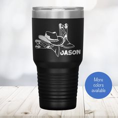 a black tumbler cup with a cowboy boot on it and the words,'more colors available '