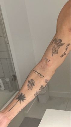 a man's arm with tattoos on it