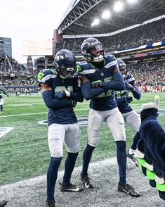 two football players hugging each other on the field