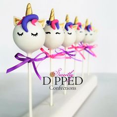 unicorn lollipops are lined up on a stick