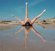 a woman laying on her back in the water with her legs spread out and one leg up