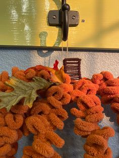 a bunch of fake leaves hanging from a hook