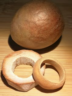 two pieces of wood sitting on top of a wooden table next to a large orange