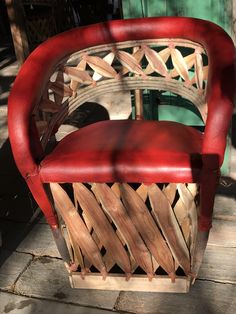 a red chair sitting on top of a wooden floor