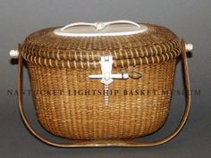 a wicker basket with a white cross on the lid and handle is shown in front of a gray background