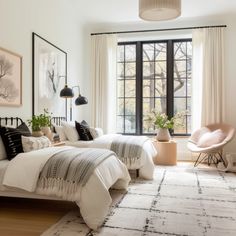 two beds in a bedroom with black and white decor